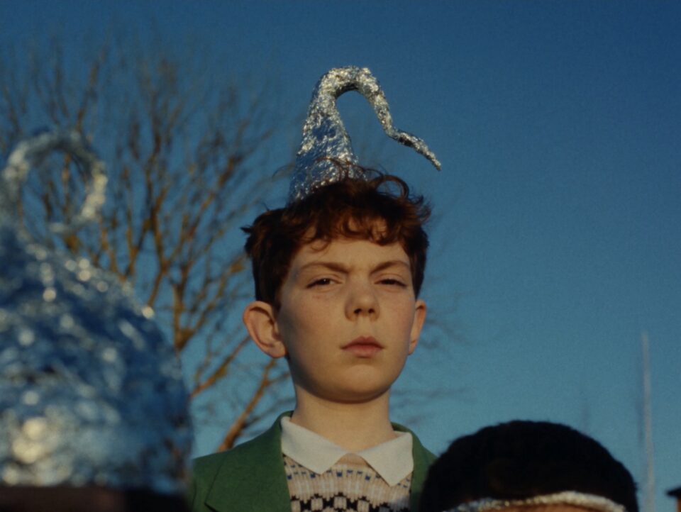 a still from a video titled "A Ffern Fairytail" featuring children wearing tinfoil hats
